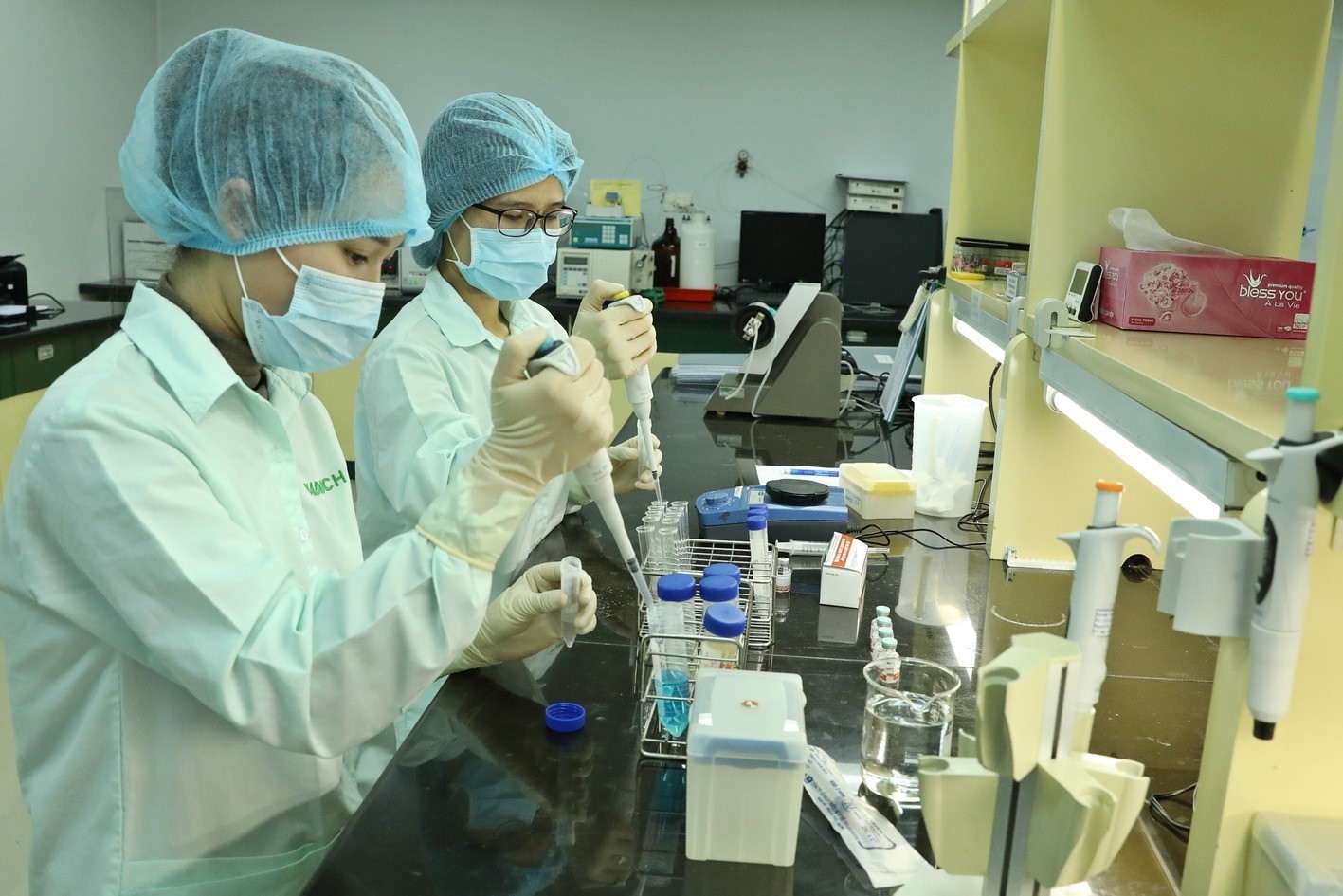 Employees at Company for Vaccine and Biological Production No 1 (VABIOTECH) examine proteins in COVID-19 vaccine.