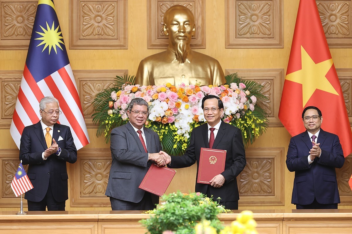 Vietnamese Prime Minister Pham Minh Chinh (first, right) and his Malaysian counterpart Ismail Sabri Yaakob (first, left) witness the exchange of cooperation agreements (Photo: VNA)
